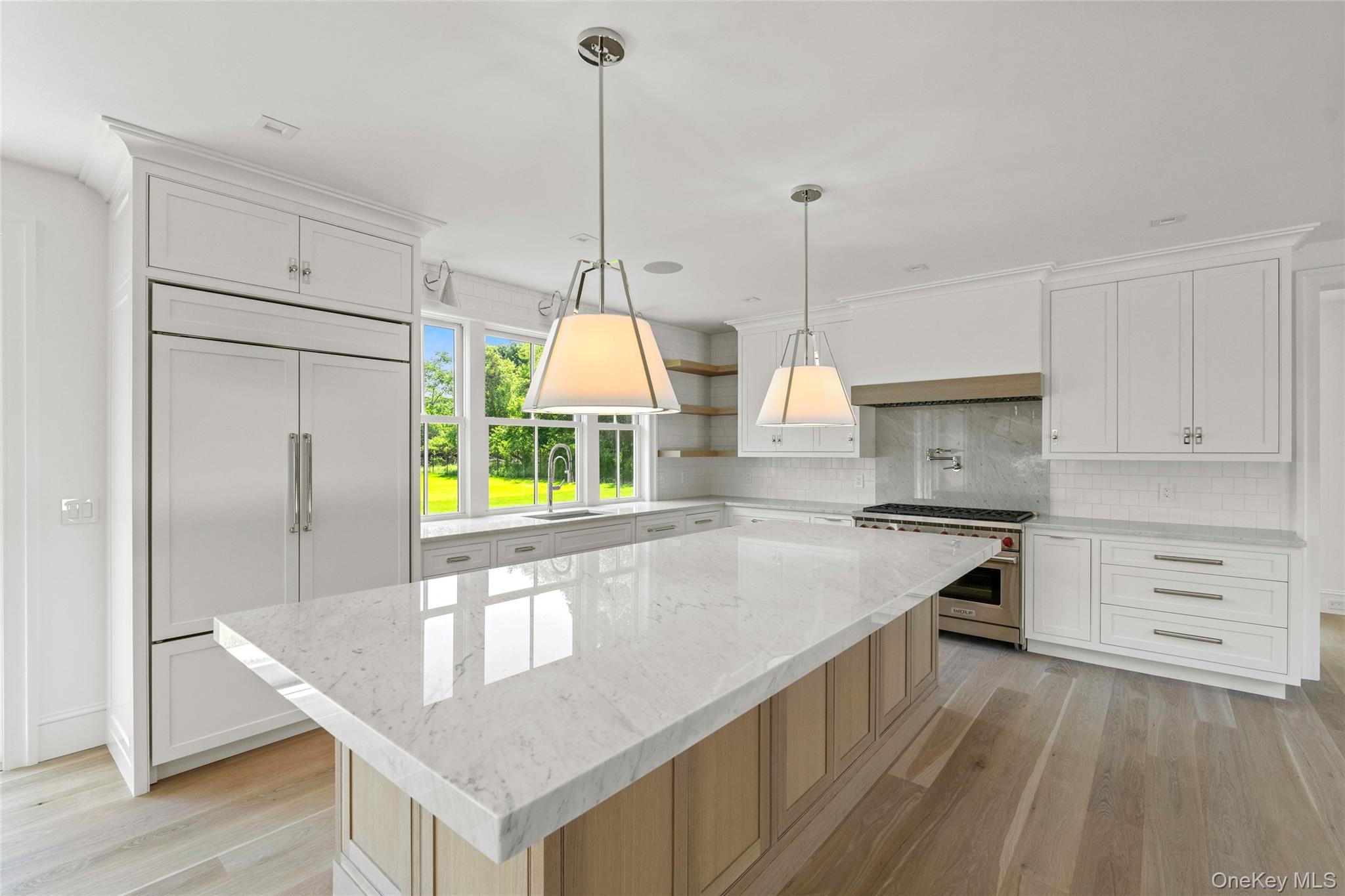 161 South Road Westhampton, NY 11977 - Photo 11 of 34 a kitchen with stainless steel appliances granite countertop a sink a stove and a wooden floor