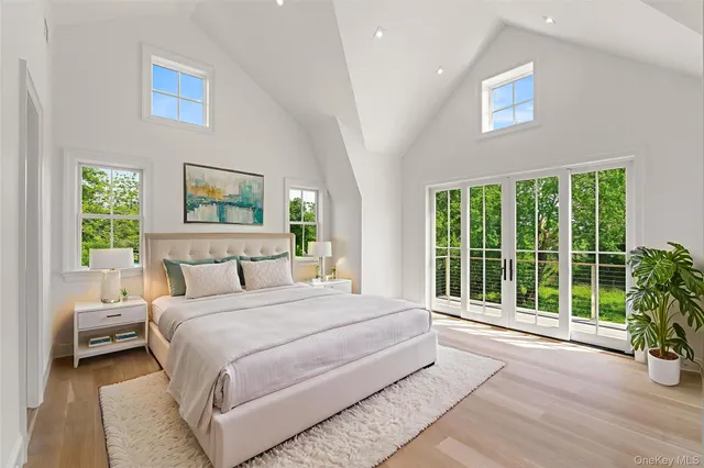 a bedroom with a large bed and a large window