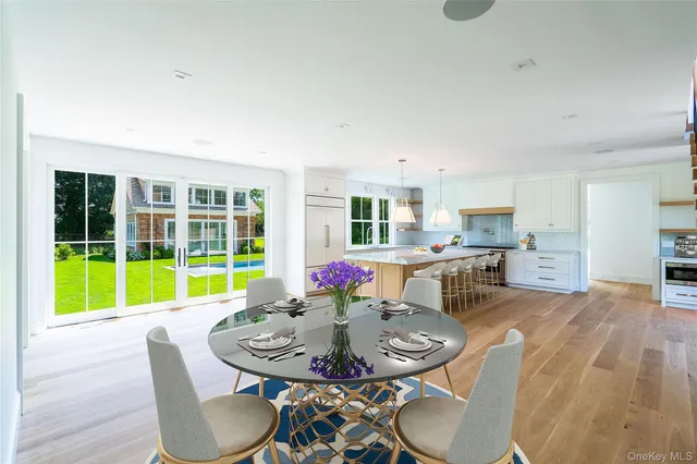a living room with furniture and a dining table with wooden floor