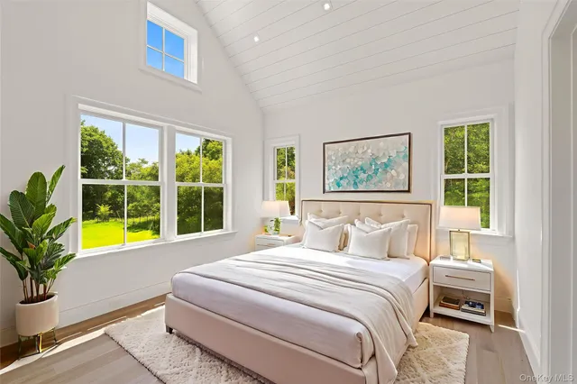 a bedroom with a large bed and a large window