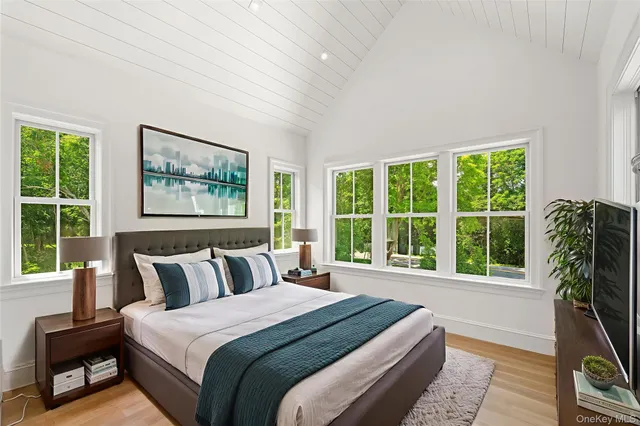 a bedroom with a large bed and a large window