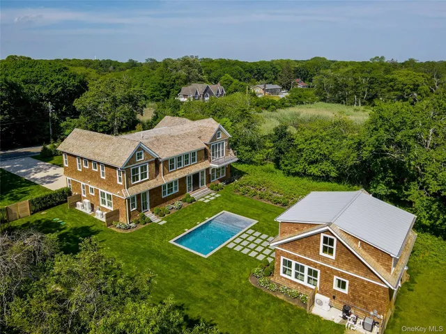 an aerial view of a house with a big yard