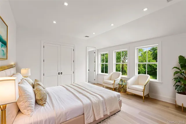 a spacious bedroom with a bed and a couch