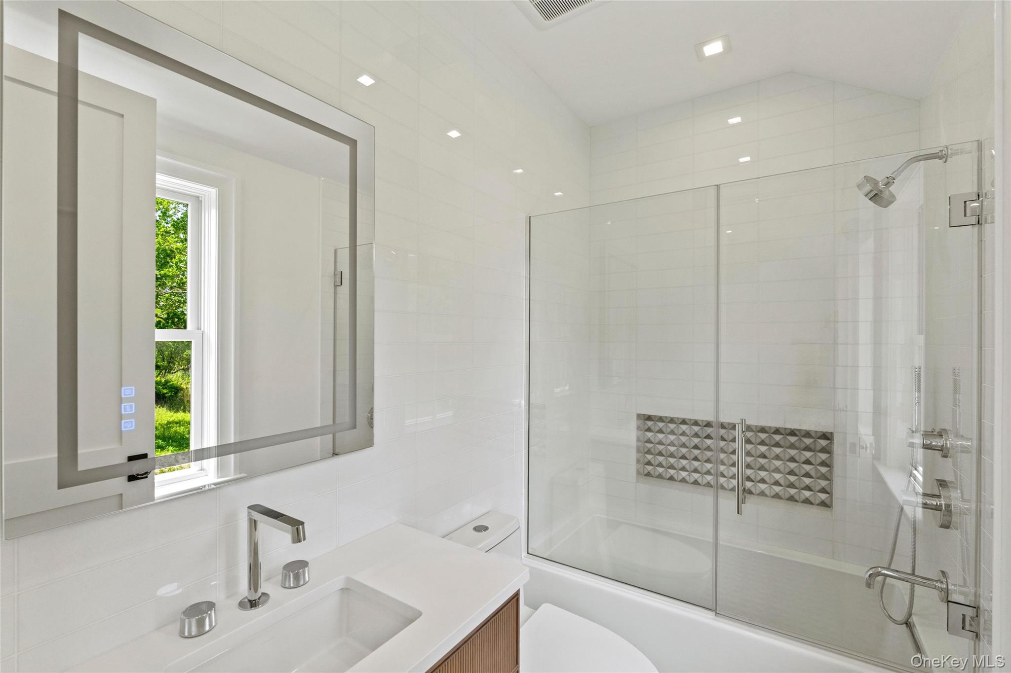 161 South Road Westhampton, NY 11977 - Photo 27 of 34 a bathroom with a bathtub a sink and a window
