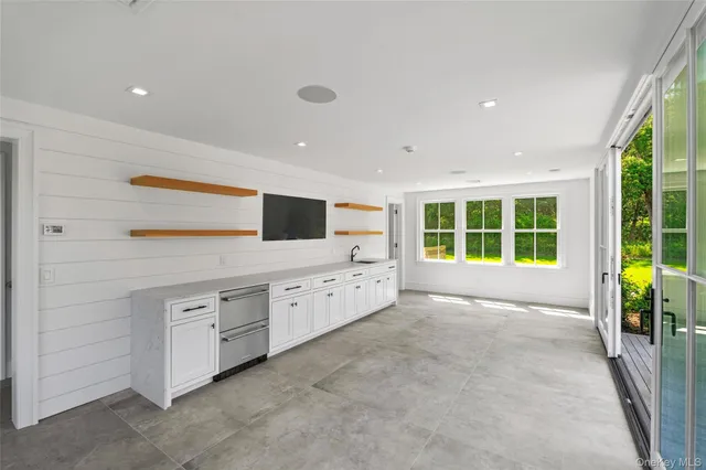 a spacious bedroom with a large bed and a window