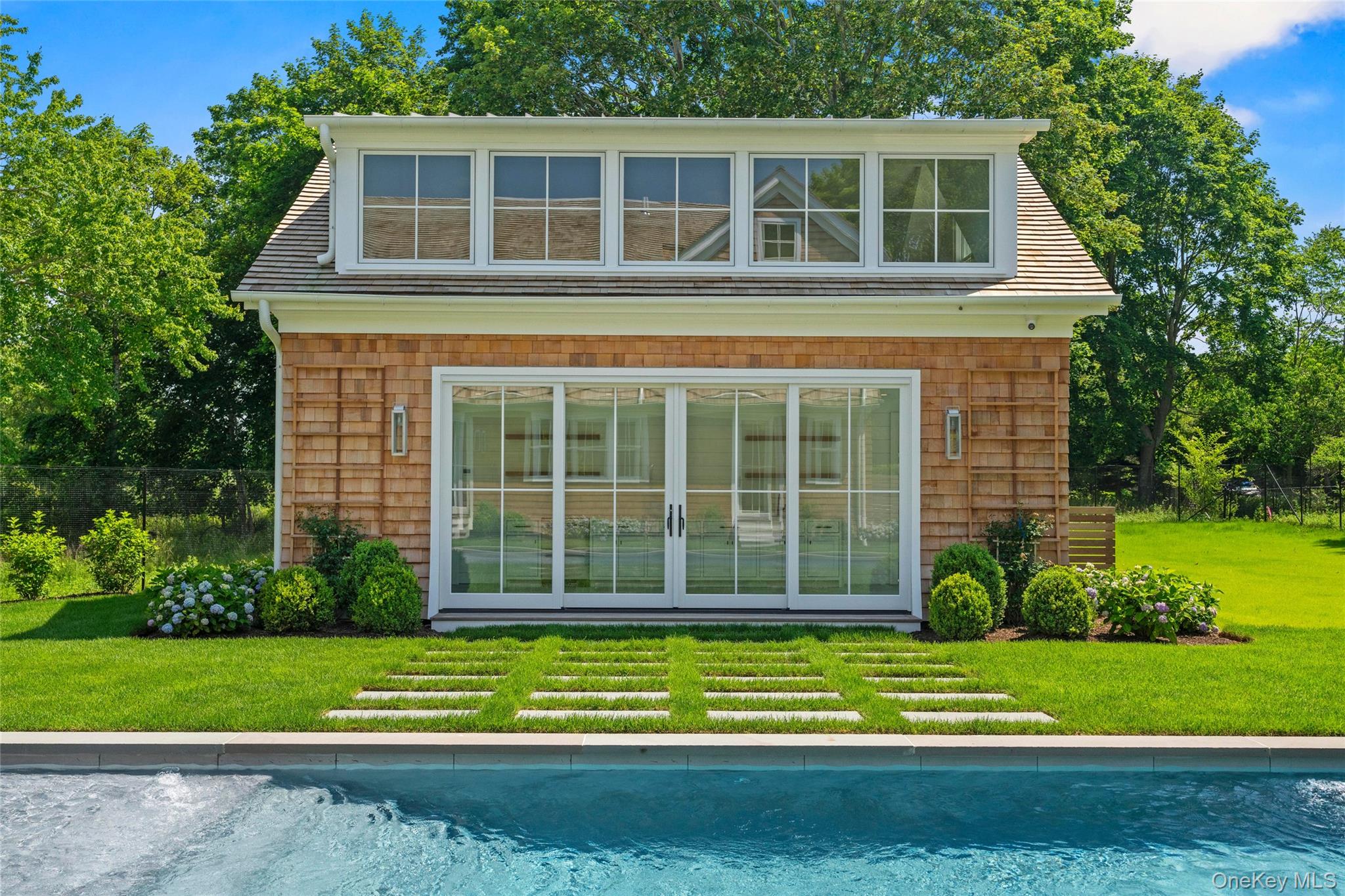 161 South Road Westhampton, NY 11977 - Photo 3 of 32 a view of a house with a yard and large trees