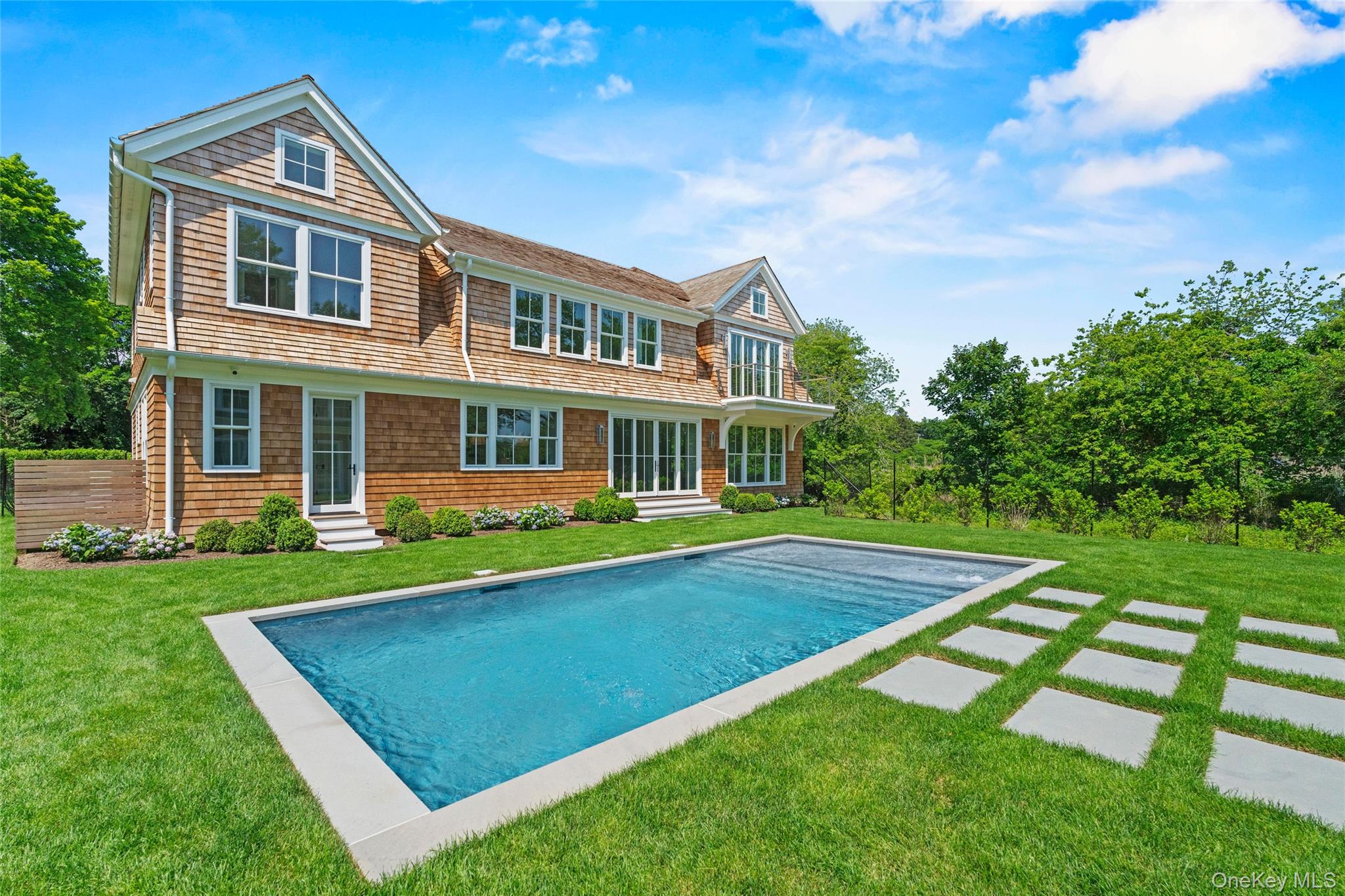 161 South Road Westhampton, NY 11977 - Photo 7 of 34 a front view of a house with yard and green space