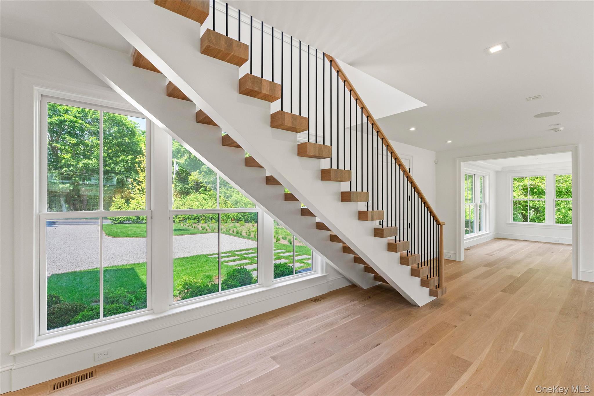 161 South Road Westhampton, NY 11977 - Photo 9 of 34 a view of staircase with wooden floor and white walls