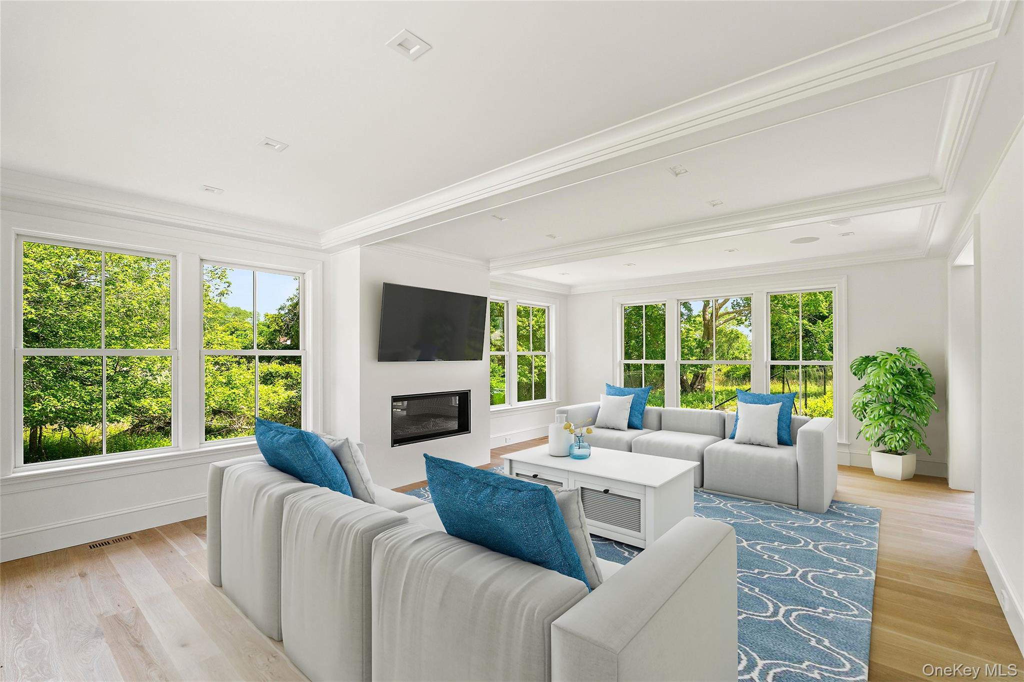 161 South Road Westhampton, NY 11977 - Photo 10 of 34 a living room with furniture large windows a flat screen tv and a fireplace