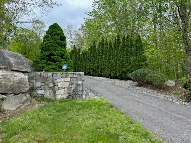 a view of a field with trees in background