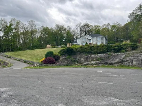a view of yard with swimming pool and green space