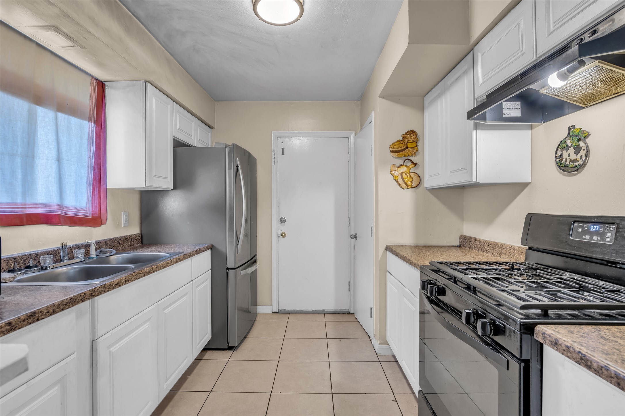 4903 Connorvale Road Houston, TX 77039 - Photo 20 of 28 a kitchen with stainless steel appliances granite countertop a sink stove and refrigerator
