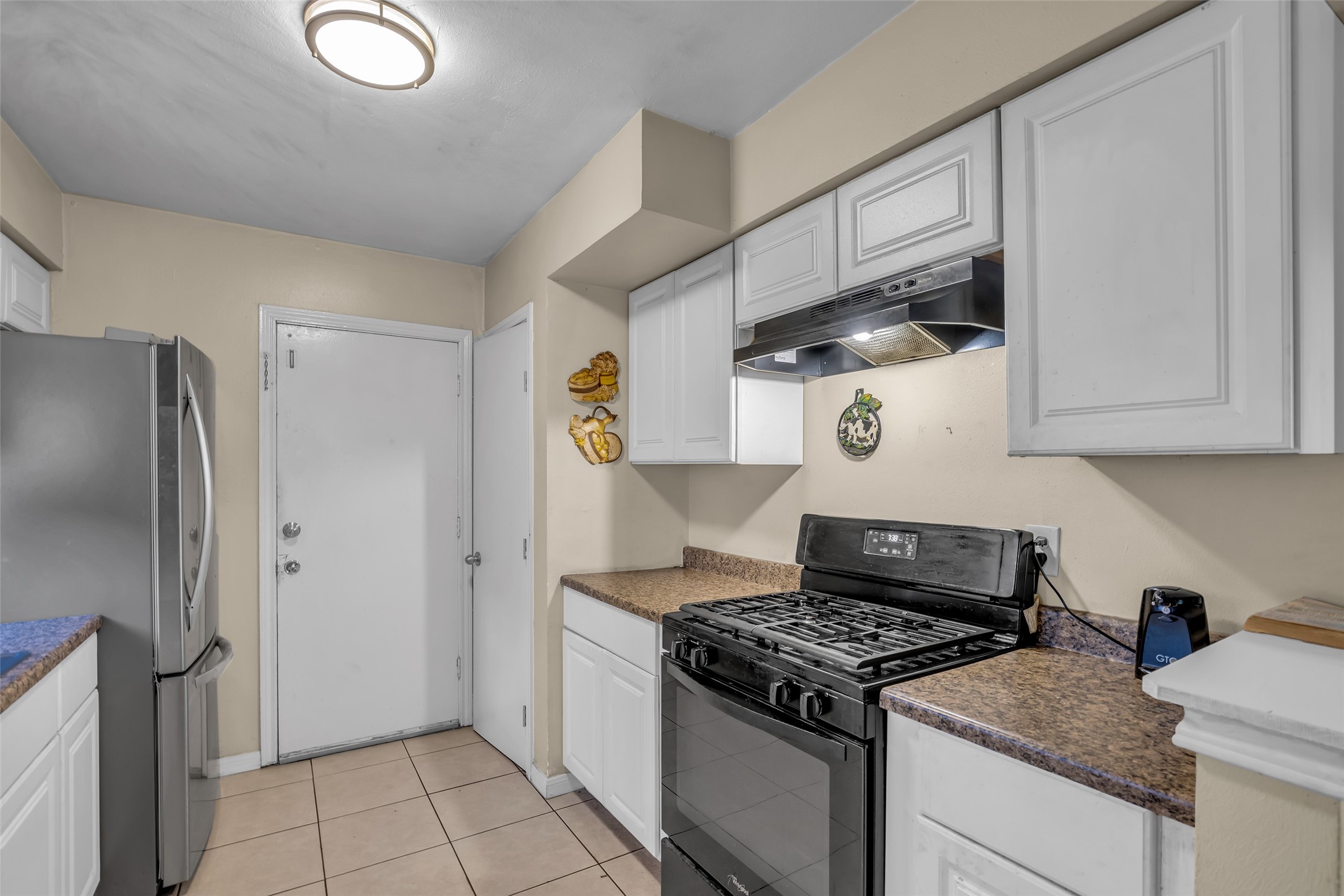 4903 Connorvale Road Houston, TX 77039 - Photo 22 of 28 a kitchen with stainless steel appliances granite countertop a sink stove and refrigerator