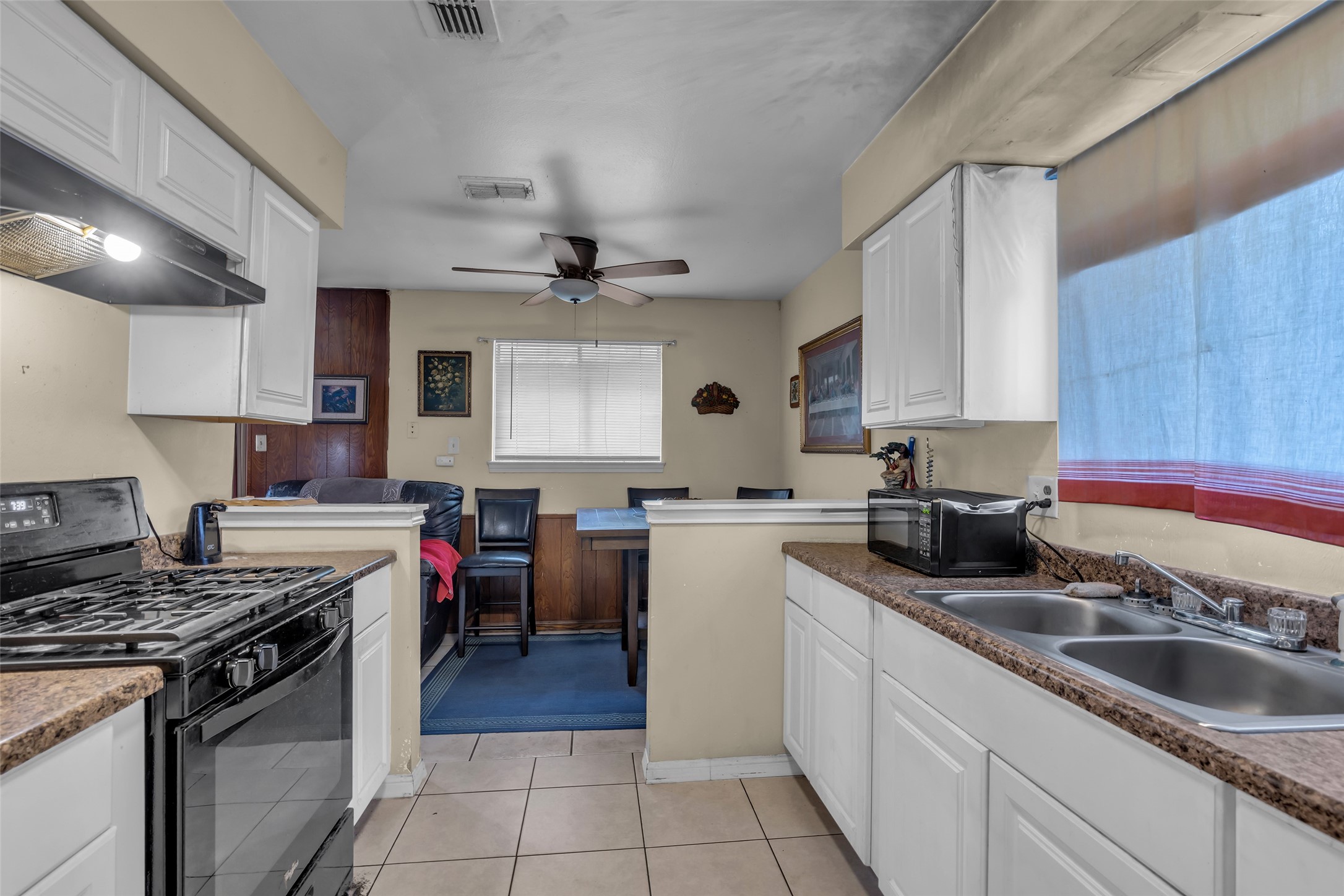 4903 Connorvale Road Houston, TX 77039 - Photo 25 of 28 a kitchen with a stove sink and cabinets