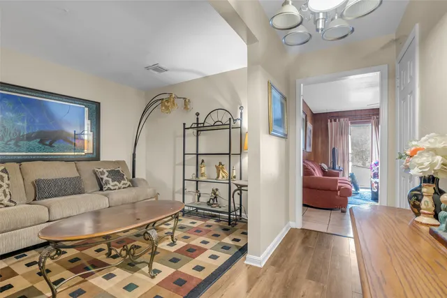 a living room with furniture and a chandelier
