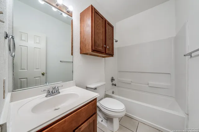 a bathroom with a sink a toilet and bathtub