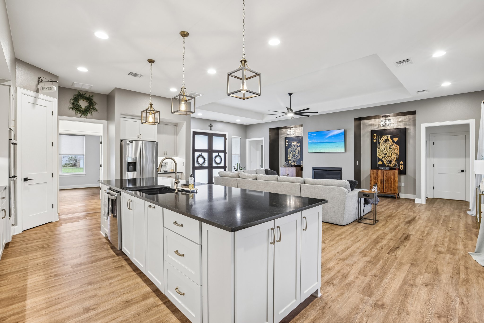 113 Crystal Lane Georgetown, TX 78633 - Photo 3 of 32 A grand kitchen island with a sleek countertop anchors this inviting open-concept living area.