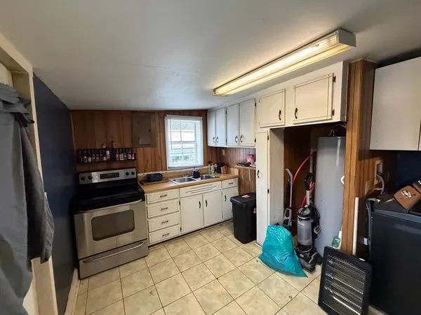 a kitchen with a sink appliances and cabinets