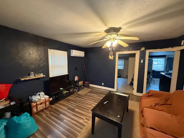 a living room with furniture and a chandelier