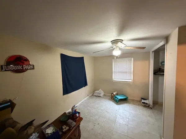a living room with furniture a flat screen tv and a window