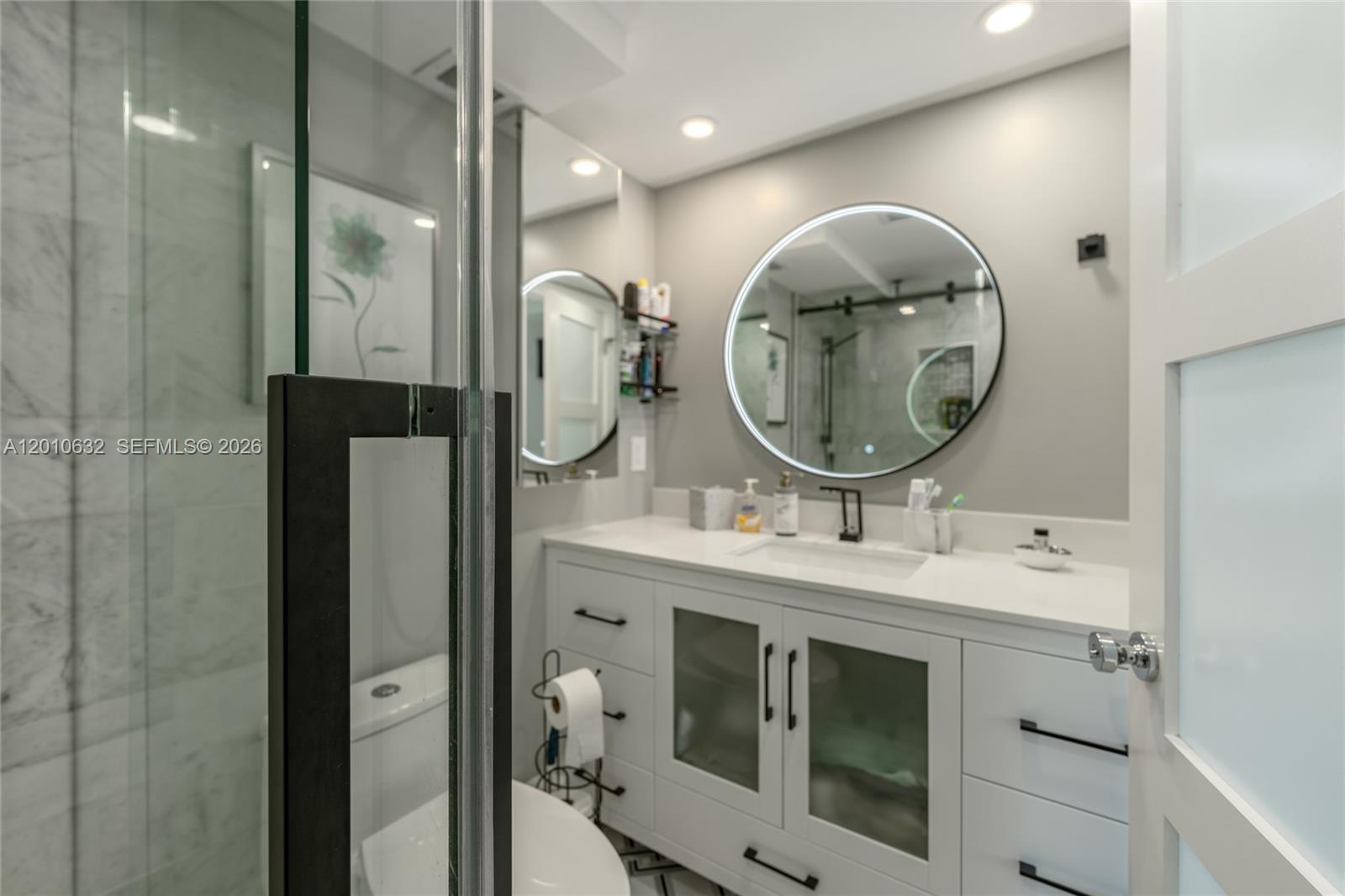 2639 North Riverside Drive, Unit 501 Pompano Beach, FL 33062 - Photo 25 of 39 a bathroom with a mirror a sink and a mirror