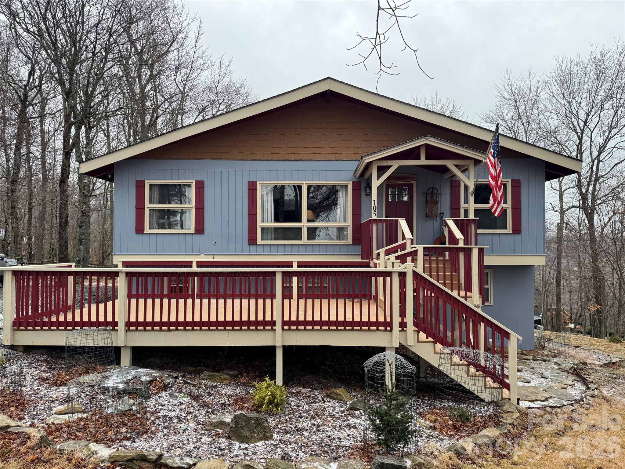 a front view of a house with deck and wooden deck