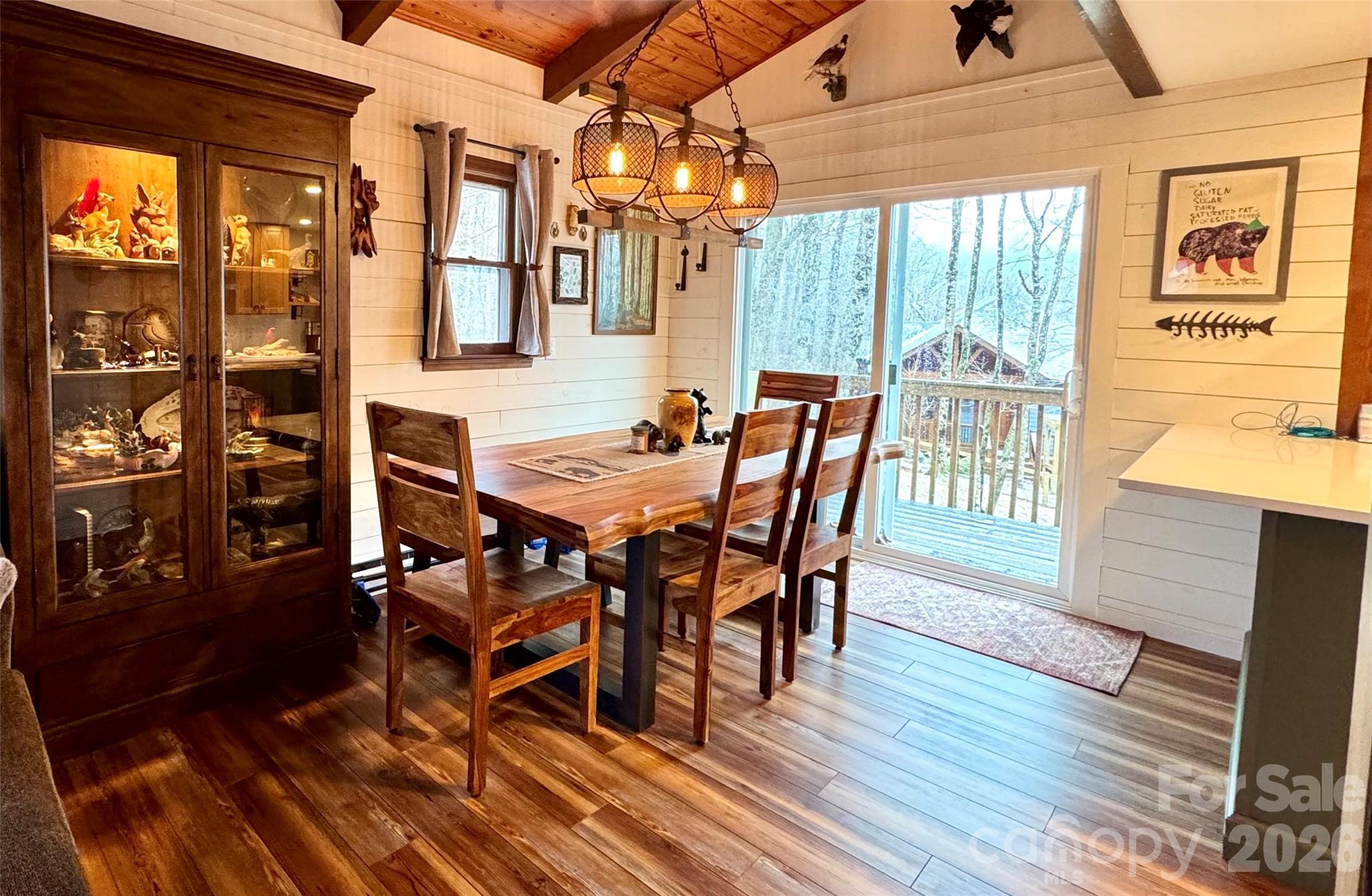 105 Pinnacle Ridge Road Beech Mountain, NC 28604 - Photo 11 of 38 a view of a dining room with furniture window and wooden floor