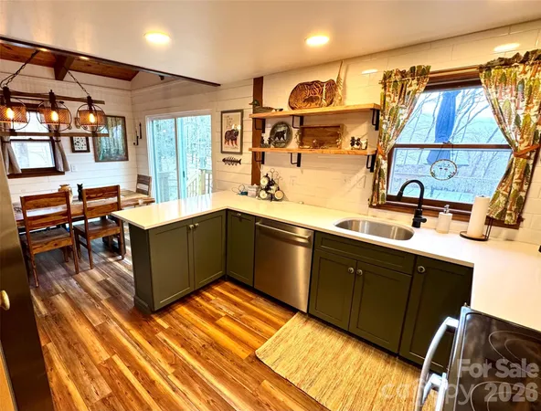 a kitchen with stainless steel appliances granite countertop a sink and cabinets
