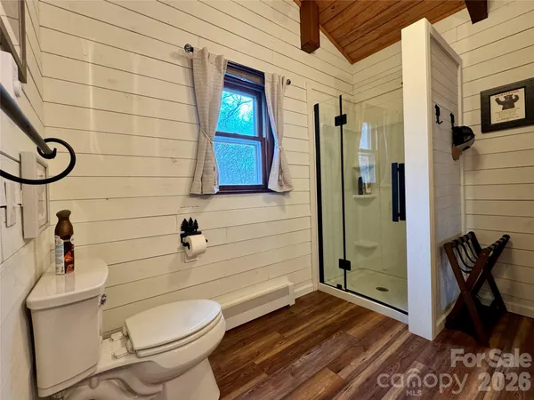 a bathroom with a toilet and a shower