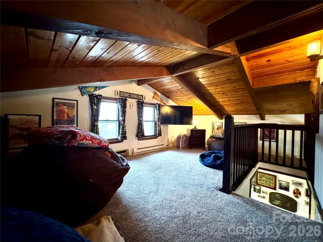 a living room with furniture a flat screen tv and gym equipment