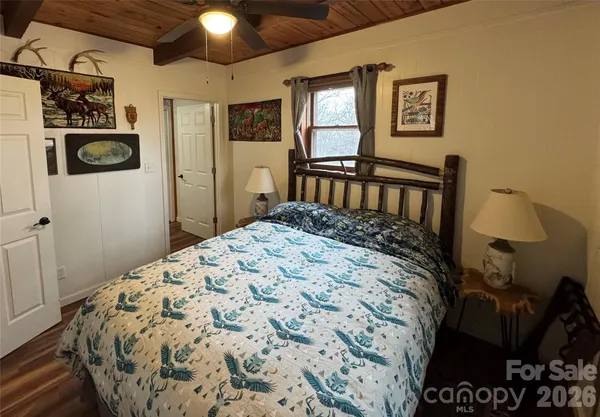 a bedroom with two beds and painting on the wall