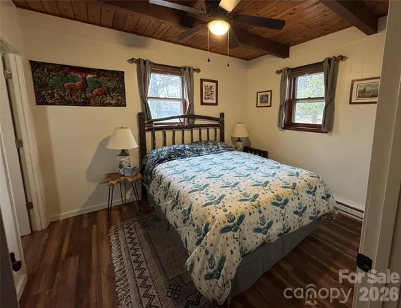 a bedroom with bed and a window