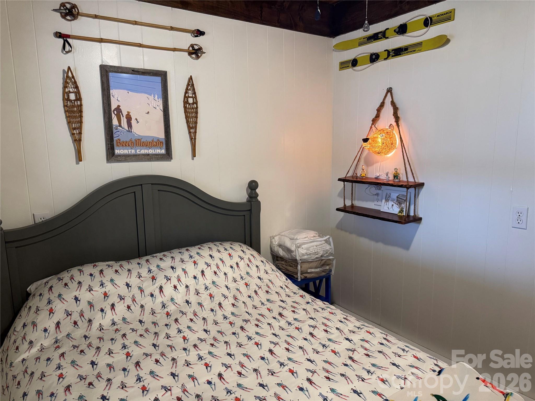 105 Pinnacle Ridge Road Beech Mountain, NC 28604 - Photo 36 of 38 a bedroom with a bed and a painting on the wall