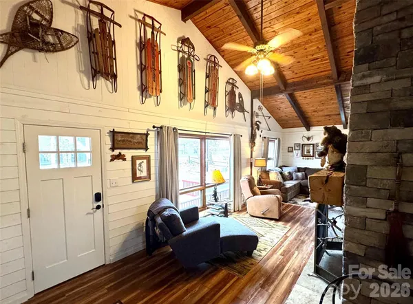 a view of a livingroom with furniture wooden floor and windows