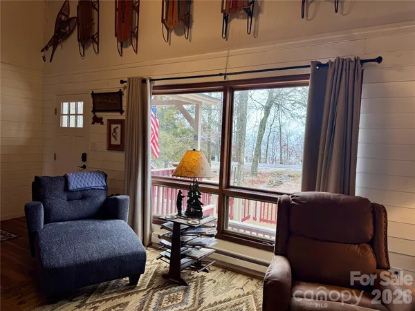 a living room with furniture and a floor to ceiling window