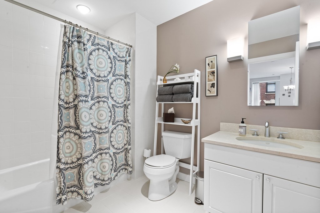 80 Broad Street, Unit 604 Boston, MA 02110 - Photo 12 of 21 a bathroom with a toilet sink and shower
