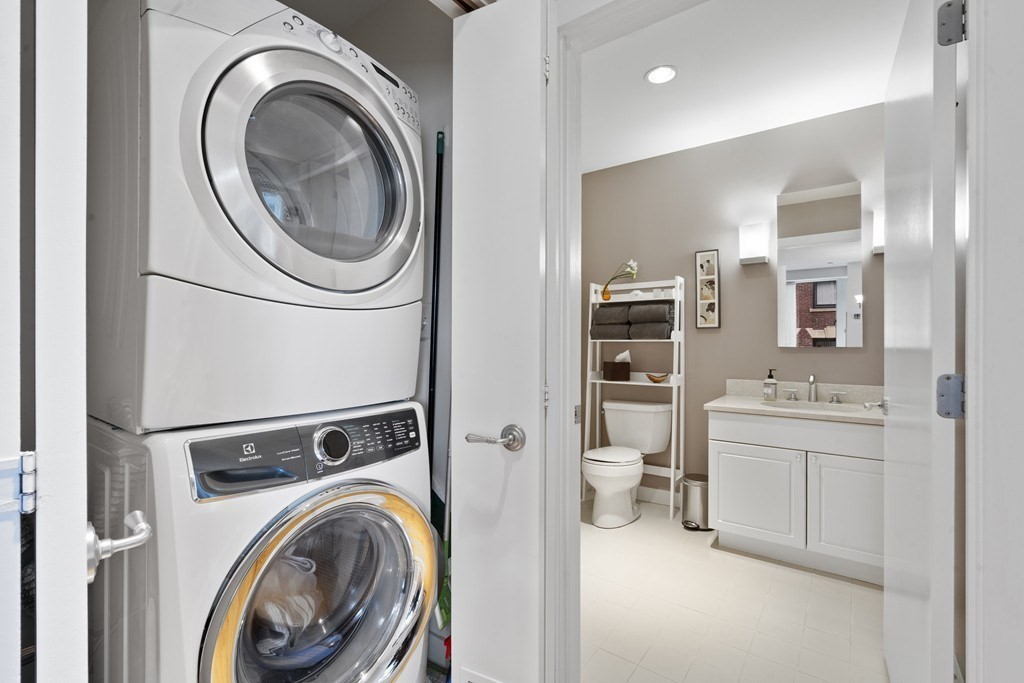 80 Broad Street, Unit 604 Boston, MA 02110 - Photo 13 of 21 a view of a hallway with washer and dryer