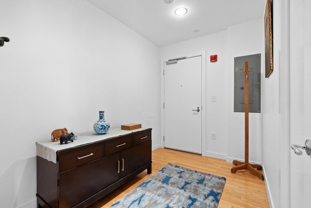 80 Broad Street, Unit 604 Boston, MA 02110 - Photo 15 of 21 a room with furniture and wooden floor