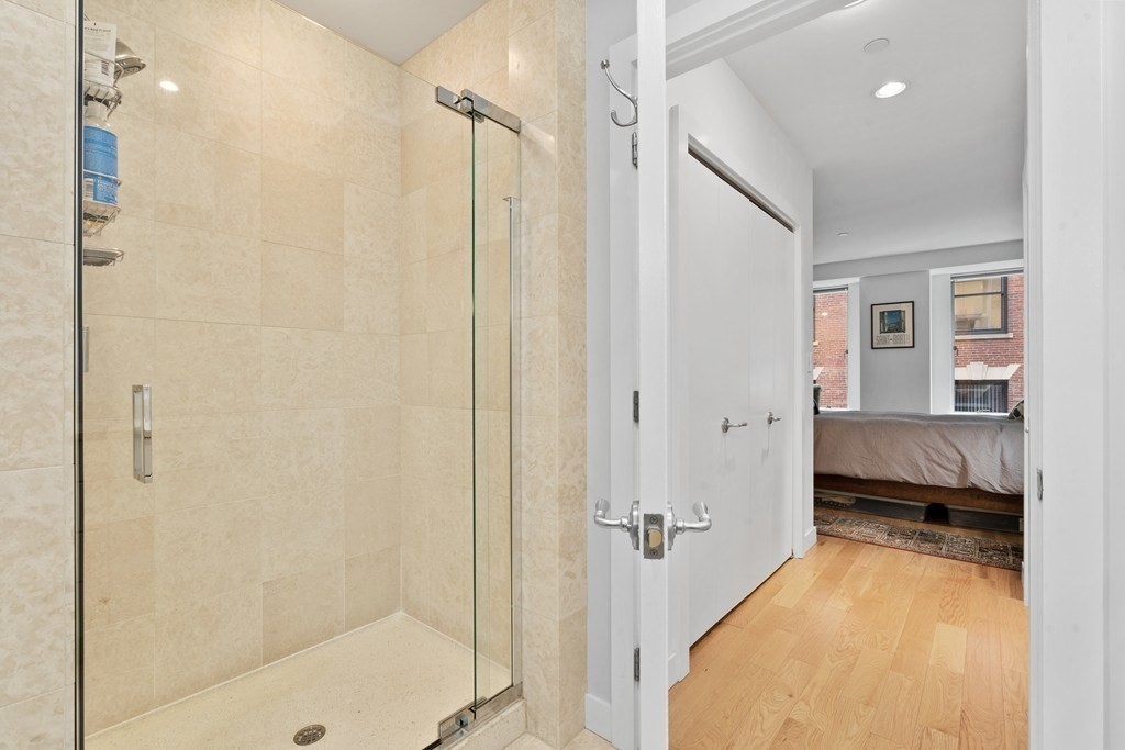 80 Broad Street, Unit 604 Boston, MA 02110 - Photo 8 of 21 a bathroom with a tub and shower