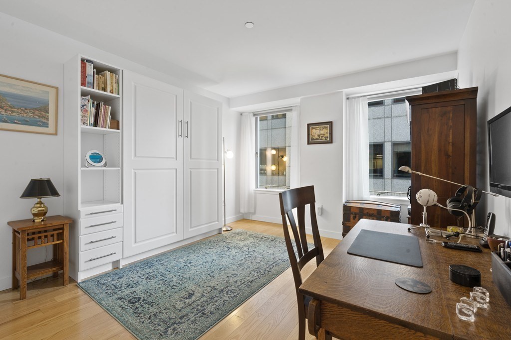 80 Broad Street, Unit 604 Boston, MA 02110 - Photo 10 of 21 a view of a workspace with furniture and bedroom view