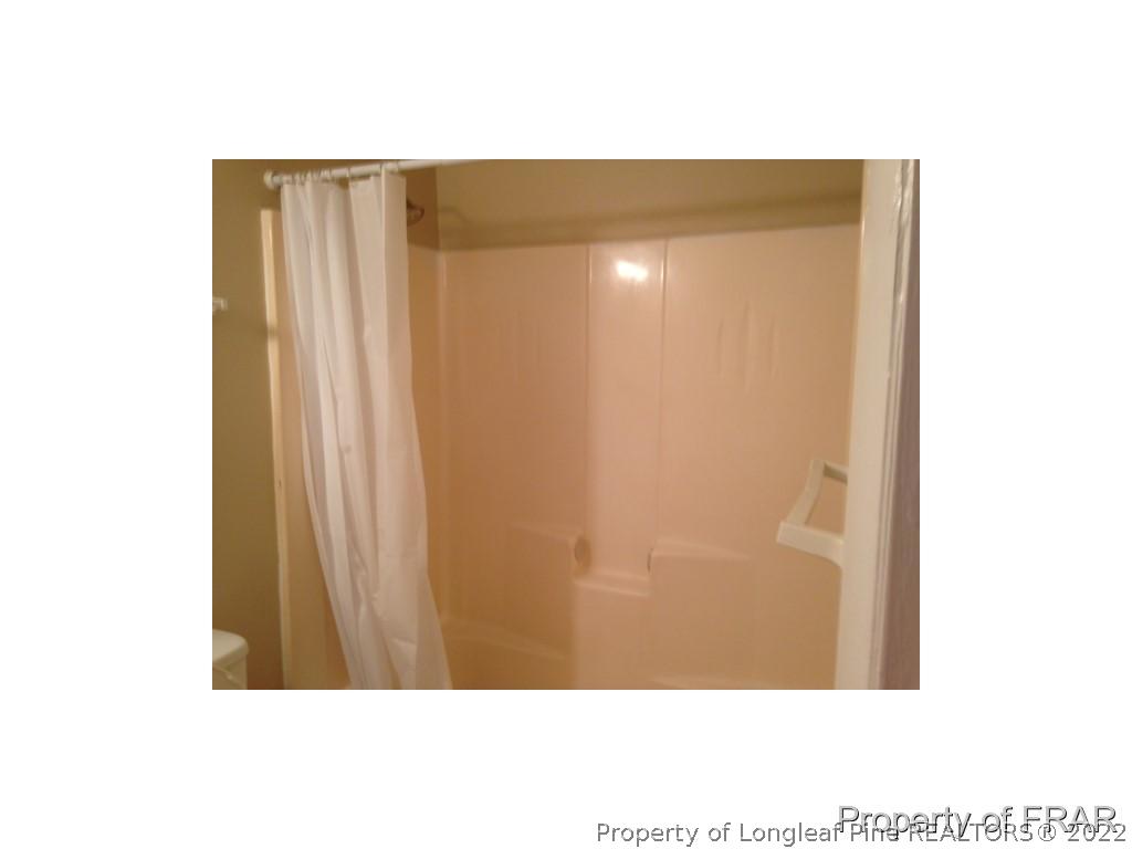 203 Duncan Road Spring Lake, NC 28390 - Photo 13 of 26 a picture of a bathroom with a shower curtain