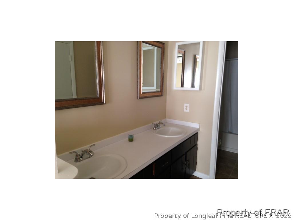 203 Duncan Road Spring Lake, NC 28390 - Photo 21 of 26 a bathroom with a sink and a mirror