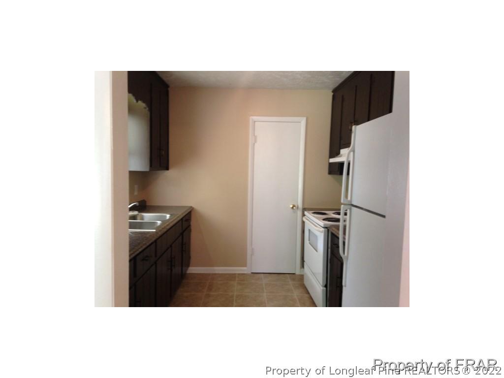 203 Duncan Road Spring Lake, NC 28390 - Photo 10 of 26 a kitchen with stainless steel appliances granite countertop a refrigerator and a stove