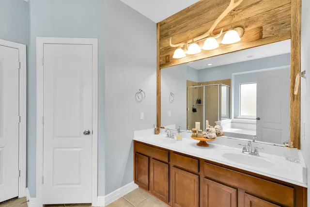 a bathroom with a double vanity sink and a mirror