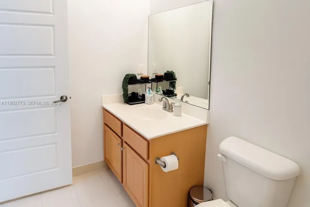 a bathroom with a sink toilet and mirror