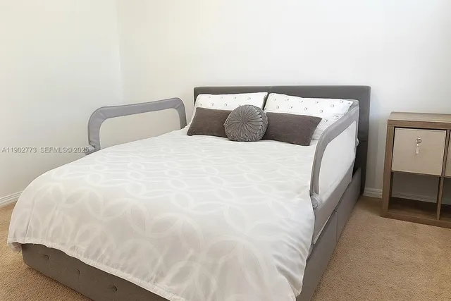 a large white bed in a small room