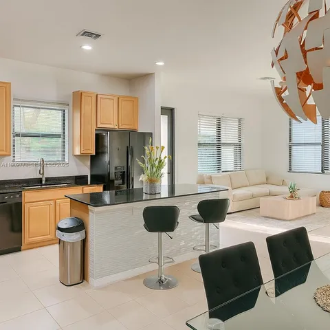 a kitchen with a dining table and chairs