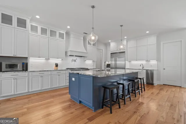 a view of a dining room with furniture a chandelier and wooden floor
