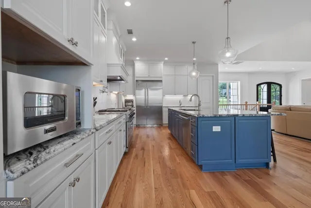 a spacious bedroom with a bed and a flat screen tv