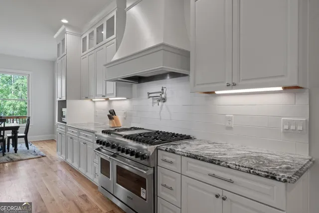 a bathroom with a granite countertop sink mirror and